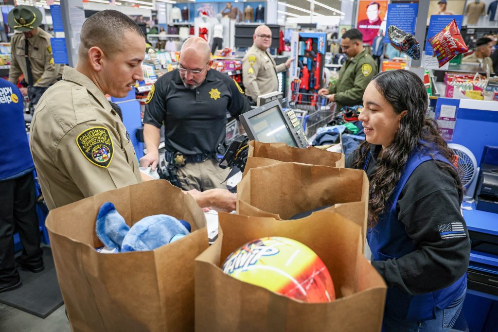 Cadet and parole agent take a kid shopping for the holidays in Galt, California.