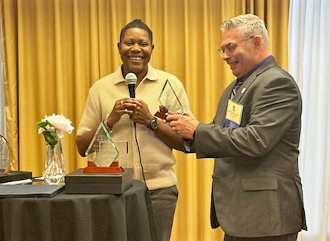 Affie Tamuno-Koko, Chief Nurse Executive, presents the award to AD Bryan Phillips.