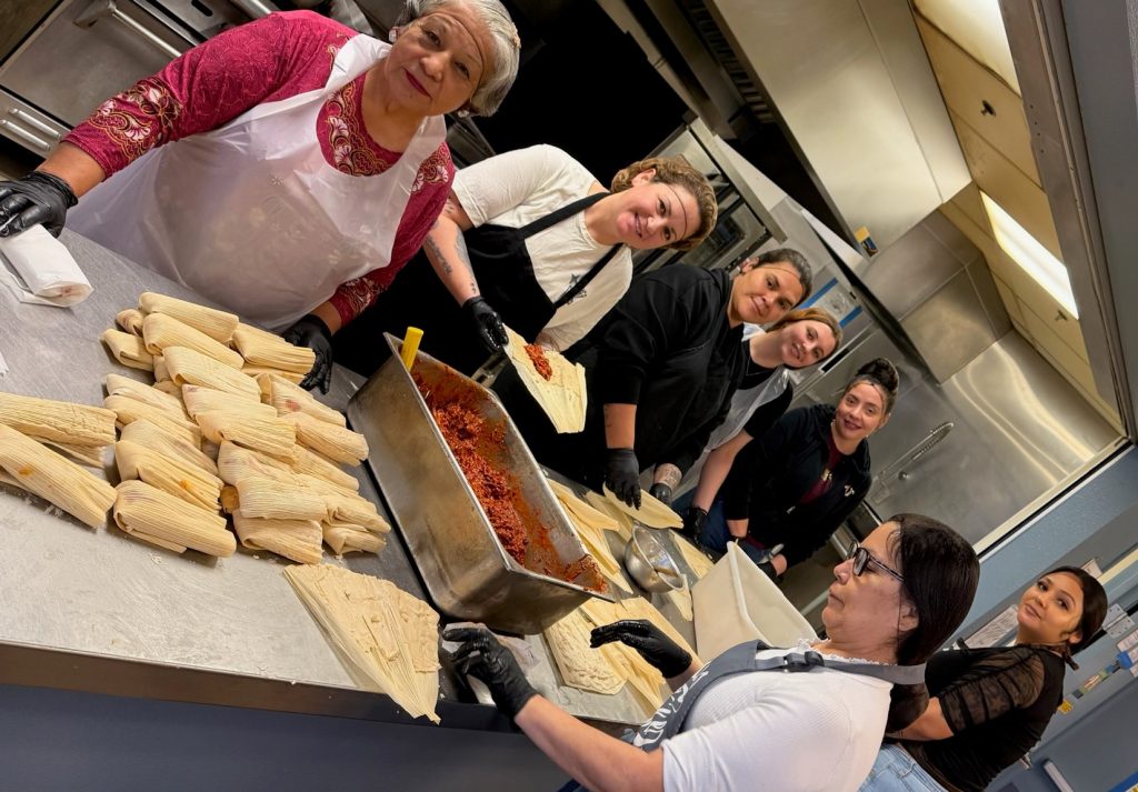 Participants at FCRP-Sacramento make tamales in the kitchen. 