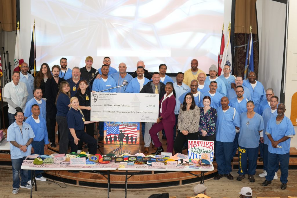 Incarcerated presenting check donation to Mather Veterans Village