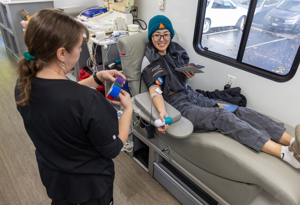 A staff member smiles while giving blood in Elk Grove, California.