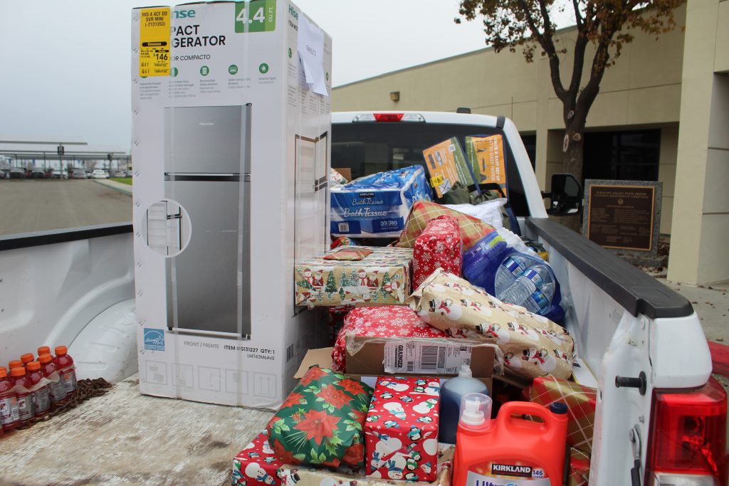Gifts being delivered to a family in need by Pleasant Valley State Prison Plants Ops. 