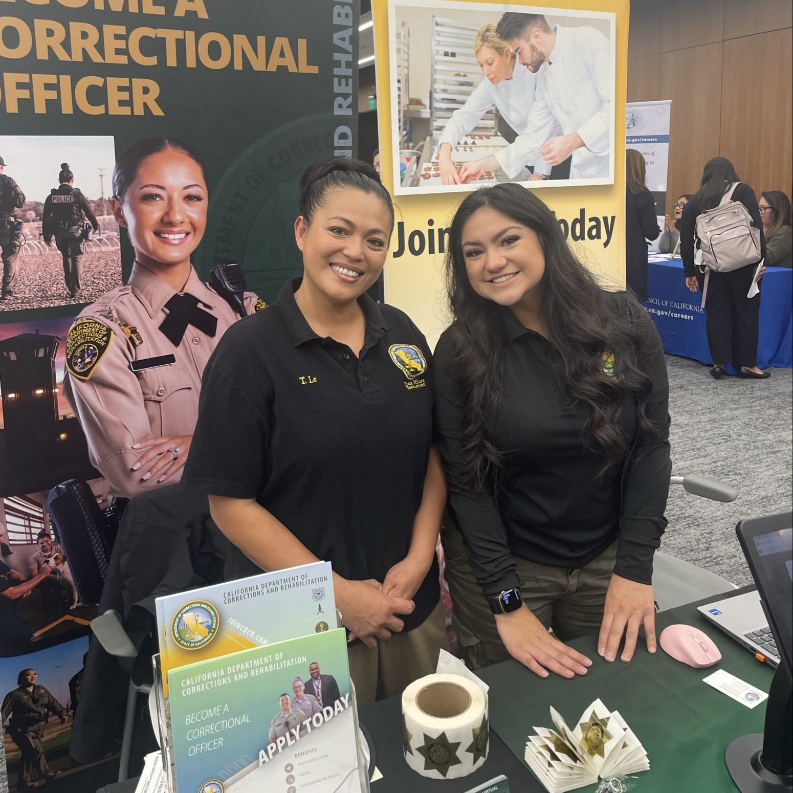 RECRUITMENT TEAM SMILING AT JOB FAIR