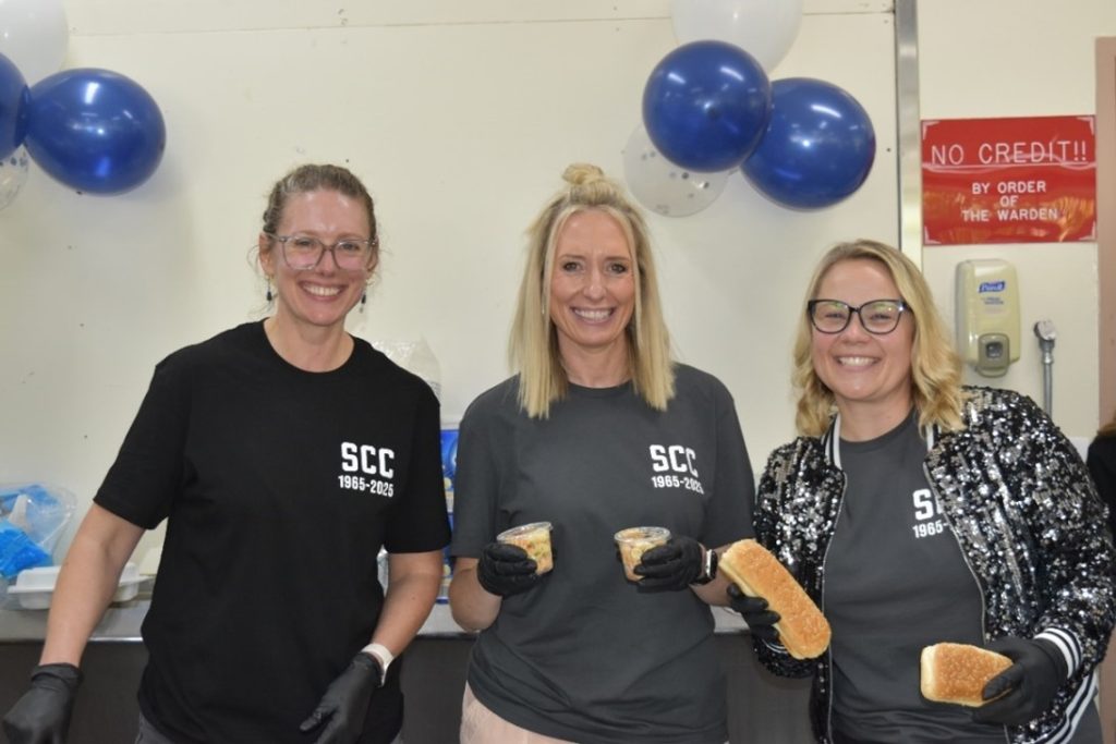 Three employees sport staff appreciation t-shirts at SCC.