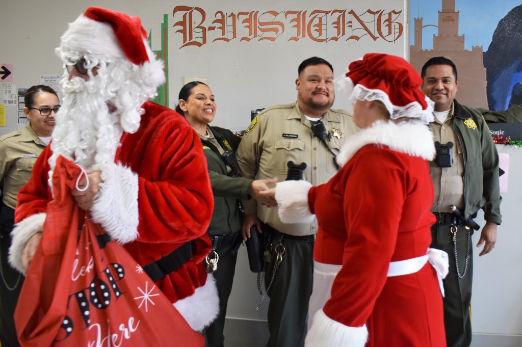 At B Visiting at Salinas Valley State Prison, Santa and Mrs. Claus greet staff as they arrive.