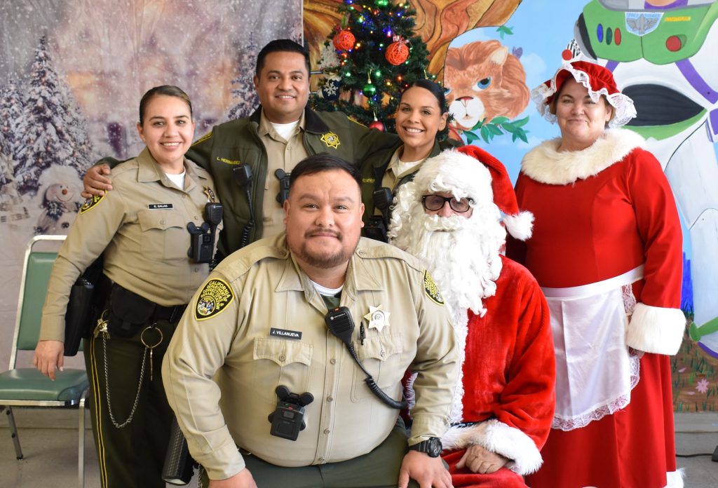 Visiting staff gets a photo with Santa at Salinas Valley State Prison. 