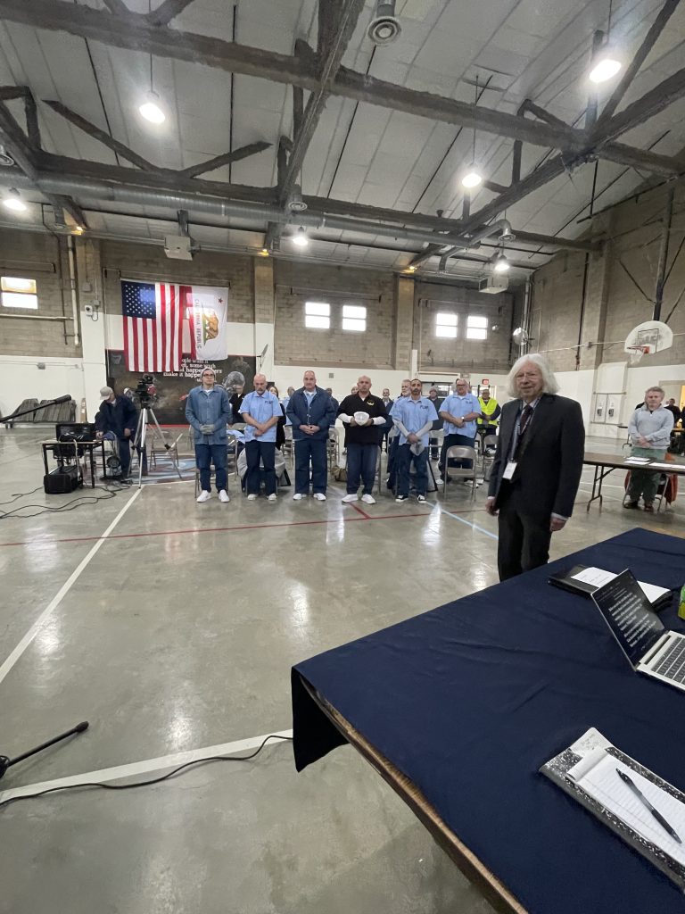 debate moderator and debaters in the background