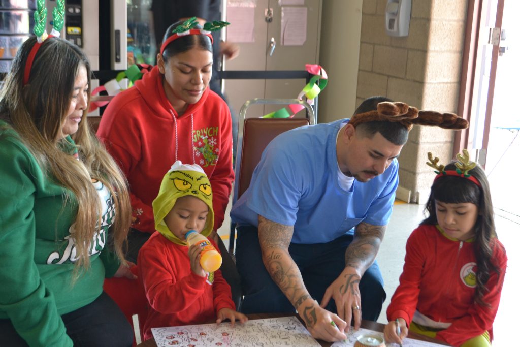 A family visiting their incarcerated loved one does crafts for the holidays at Valley State Prison in Chowchilla. 