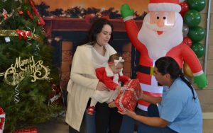 An incarcerated person gives a gift to his child during a holiday visiting event at Valley State Prison in Chowchilla.
