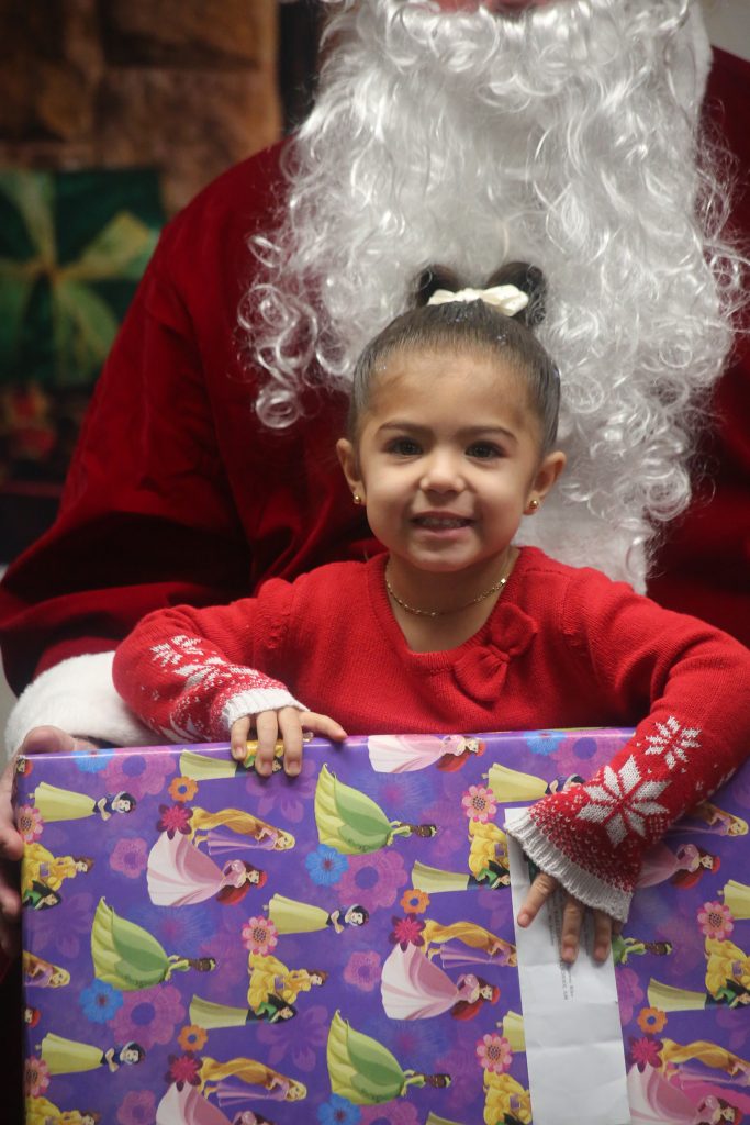 Happy child gets a present from WSP-RC. 
