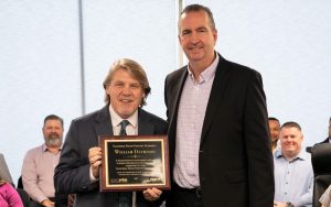 General Manager Bill Davidson holds his CALPIA retirement plaque alongside CDCR Secretary Jeff Macomber.