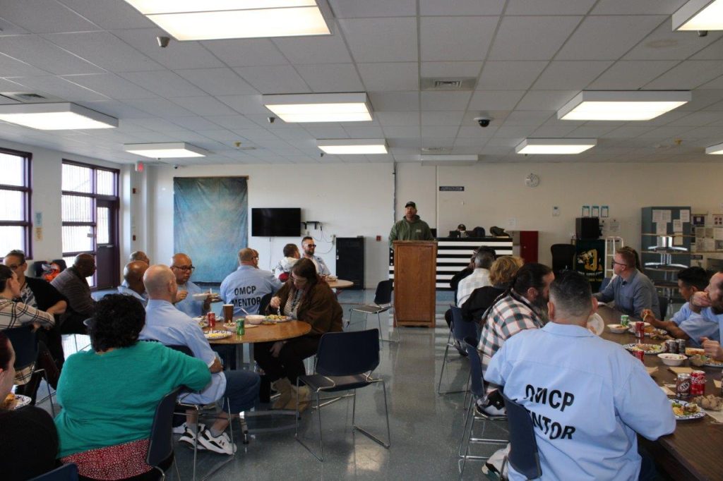 participants eating lunch, listening to a guest speaker