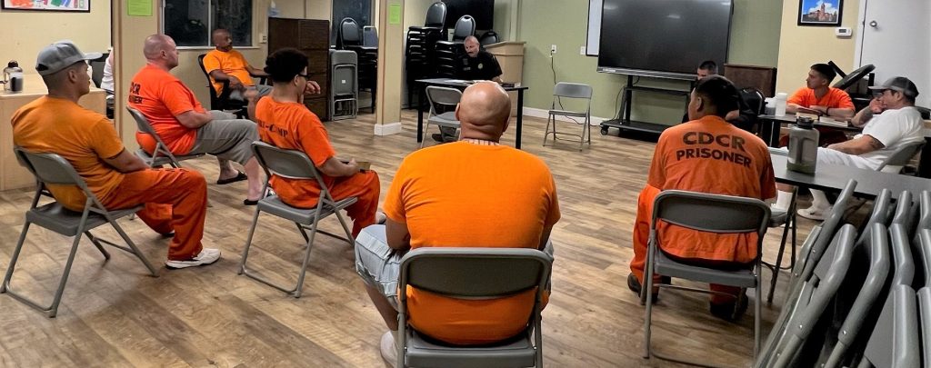 Incarcerated people sitting in a circle for a Bible study at Pine Grove Youth Conservation Center.
