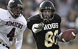 Players on a field for the annual Pig Bowl Guns and Hoses charity football game.