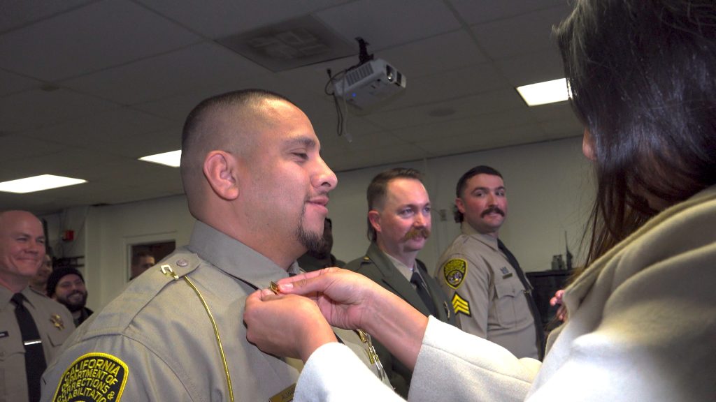 Staff member pinned with rank during a ceremony at CSP-Sacramento.