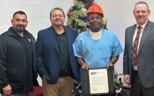 San Quentin pre-apprenticeship mentor program graduate with supporters and his instructor.