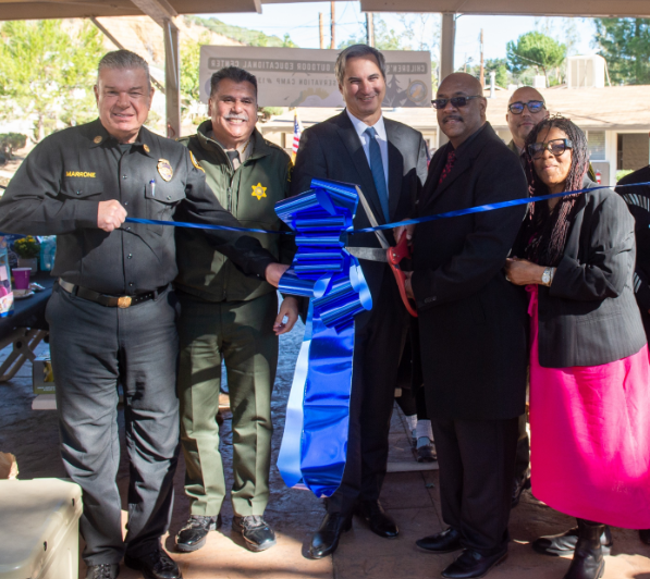 Gordon Philanthropies staff and CDCR staff cutting ribbon