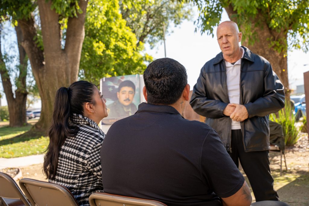 Staff member speaks with Gonzalez family.