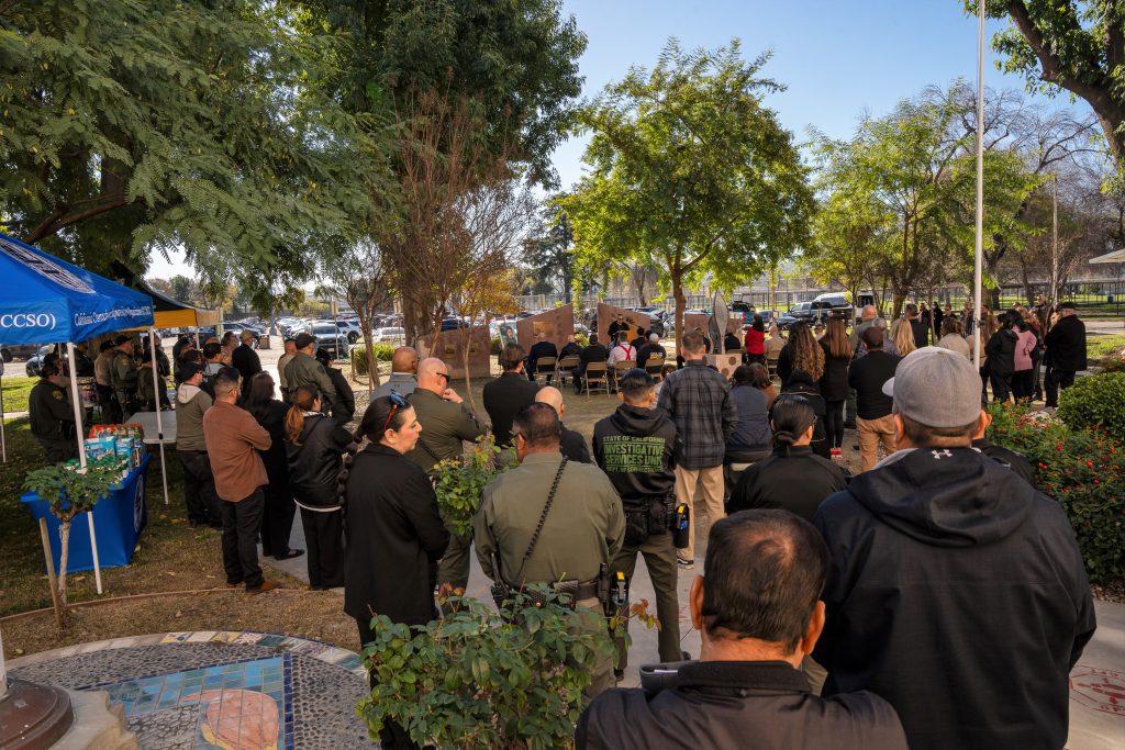 CIM staff and visitors gather in the memorial garden for the 21st annual remembrance ceremony in honor of Officer Manuel Gonzalez. 