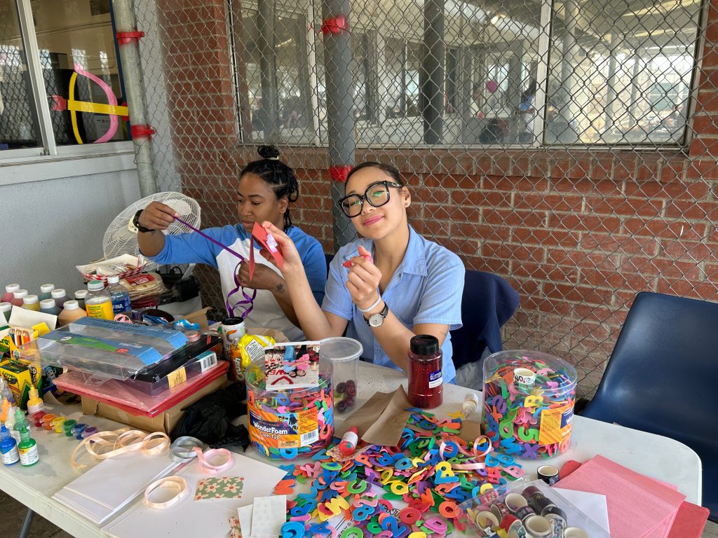Two people doing crafts during CIW Valentine's Day family event