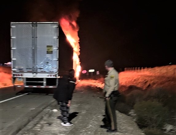 A correctional officer from CMC helps a truck driver whose vehicle caught on fire.