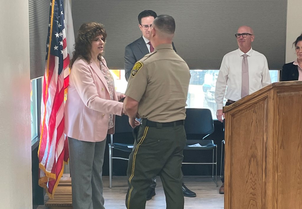 Shaking hands during promotional ceremony. 