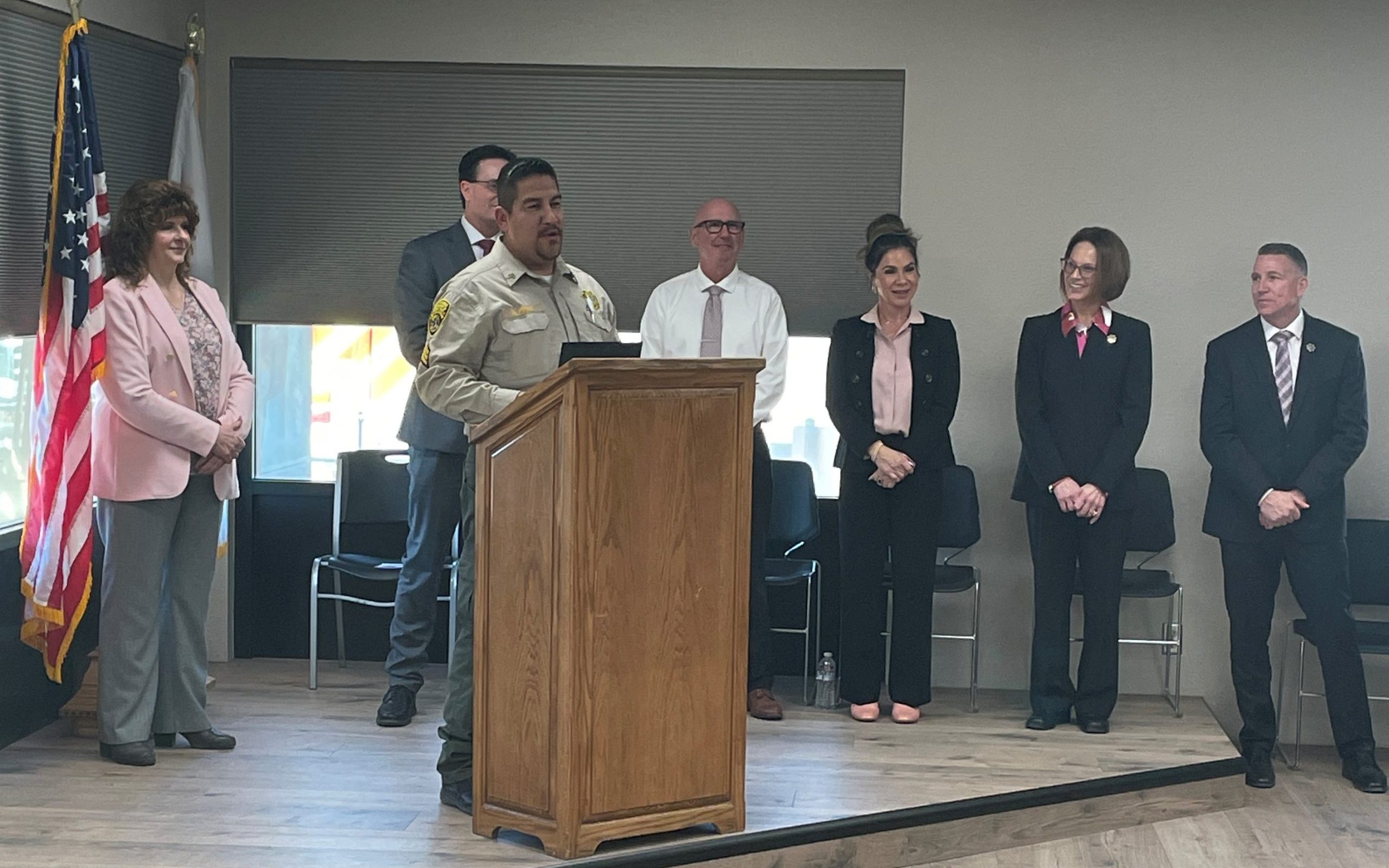 High Desert State Prison promotional ceremony with executives and someone speaking at a lectern.