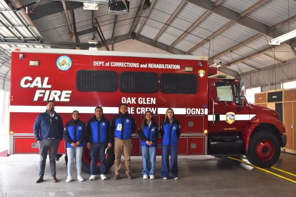 Foreign prison officials pose in front of a CALFIRE CDCR truck from Oak Glen Conservation Camp.