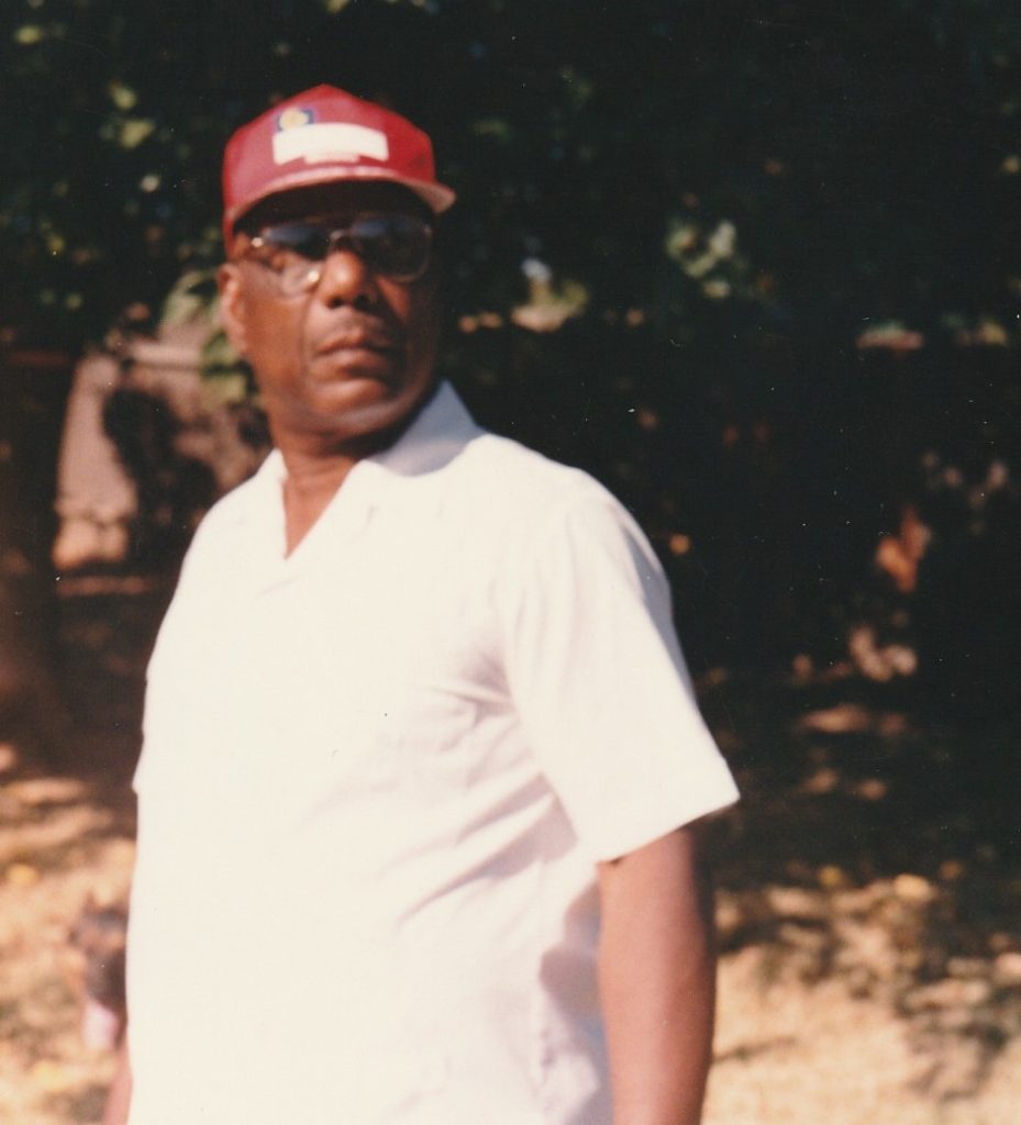 Roosevelt Ted Clopton wearing a hat and polo shirt as a college instructor.
