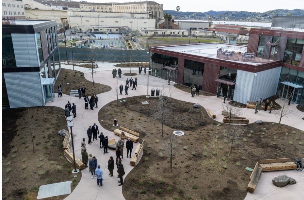 Aerial view of the San Quentin Learning Center opening with various unidentified people standing throughout the new facility.
