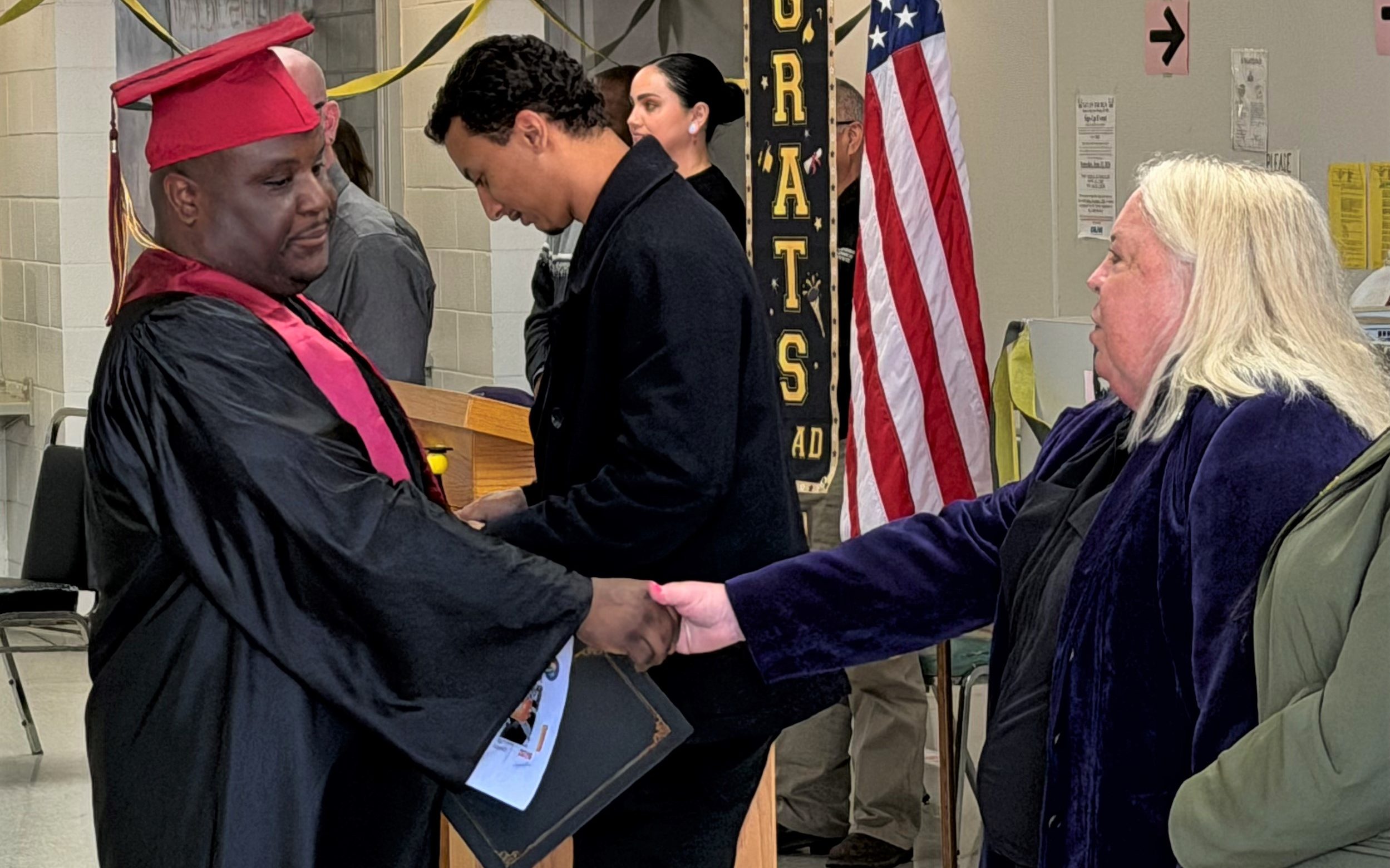 A graduate shakes hands with the warden at Salinas Valley State Prison in Soledad, February 2026.