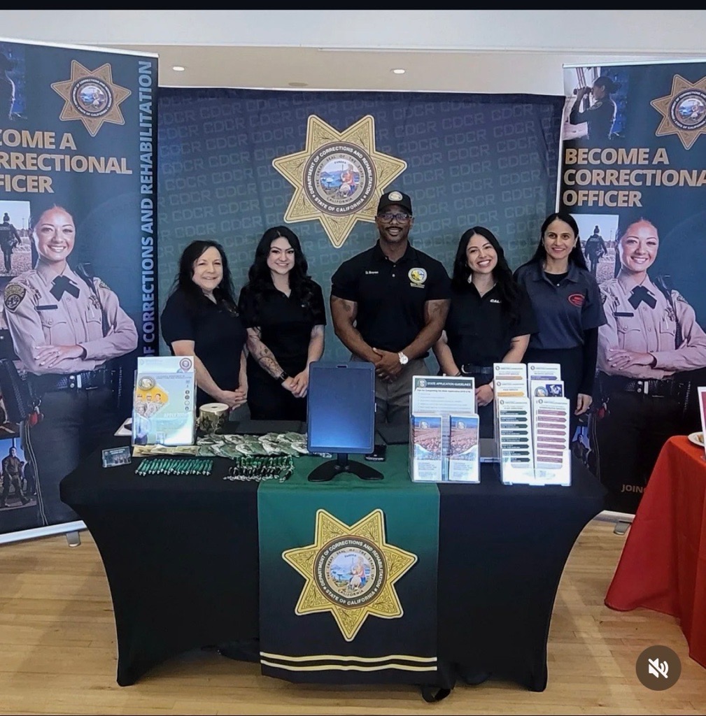 Photo of 5 CDCR employees standing at Sac Jobs Winter Career Fair table