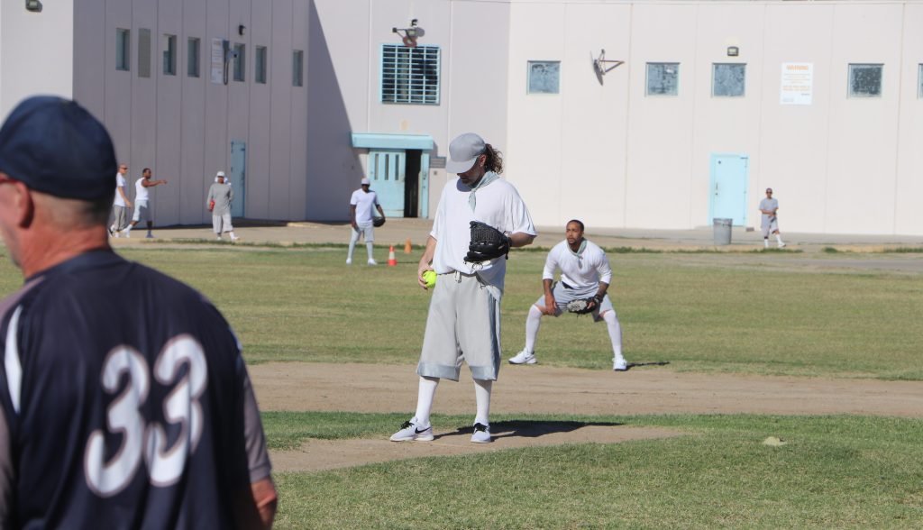 A pitcher readies himself on the mound during a softball game at Centinela State Prison.