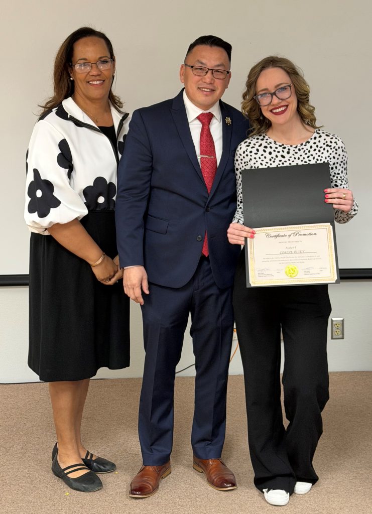 CHCF leadership with a staff member holding a certificate during the promotional ceremony.