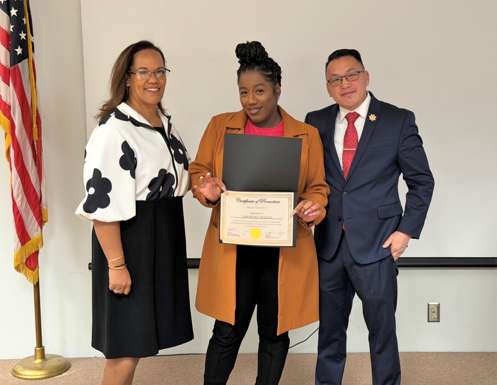 Staff member holding a certificate during the CHCF promotional ceremony.