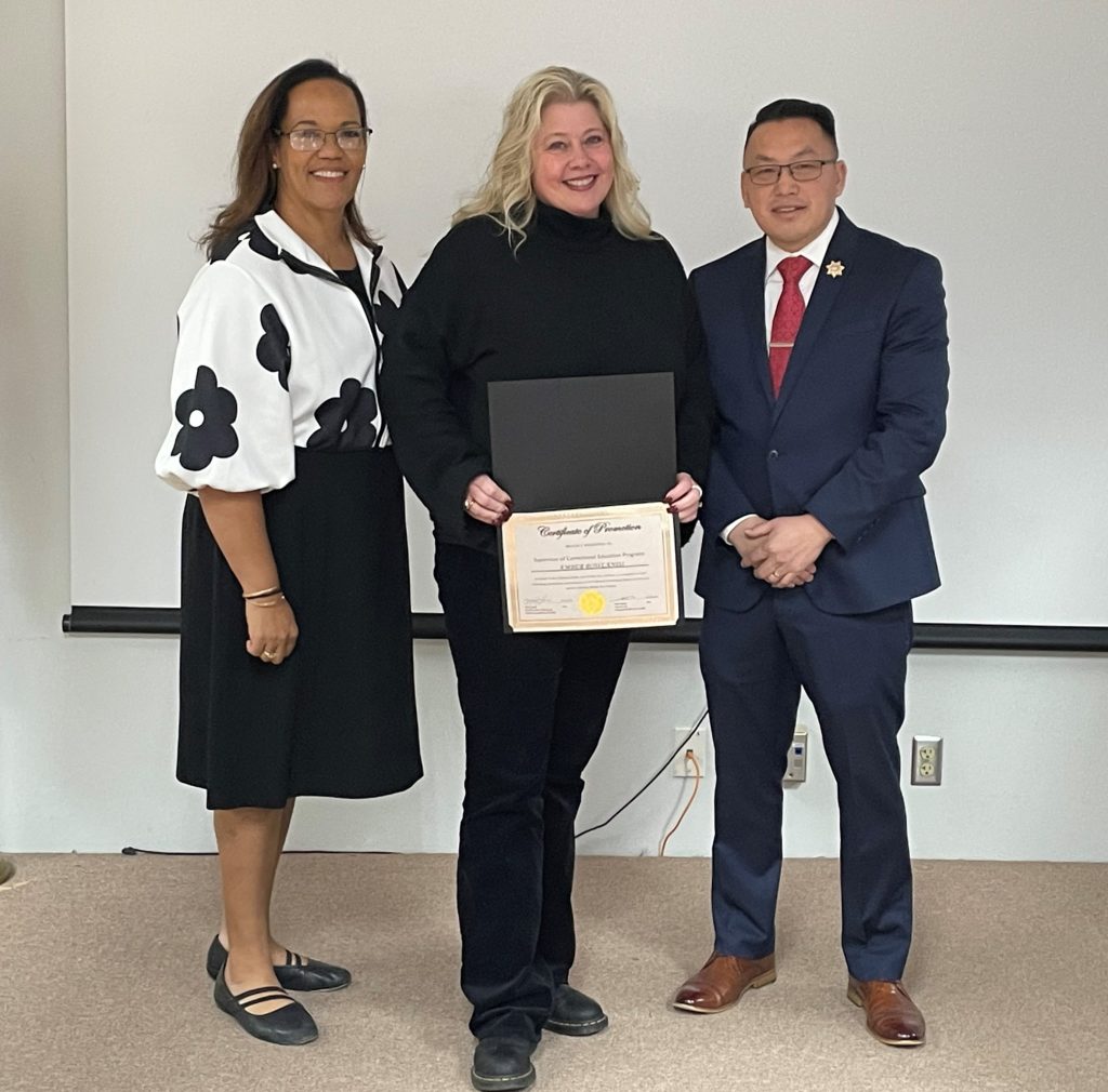 CHCF staff member holding a certificate alongside two people from leadership.