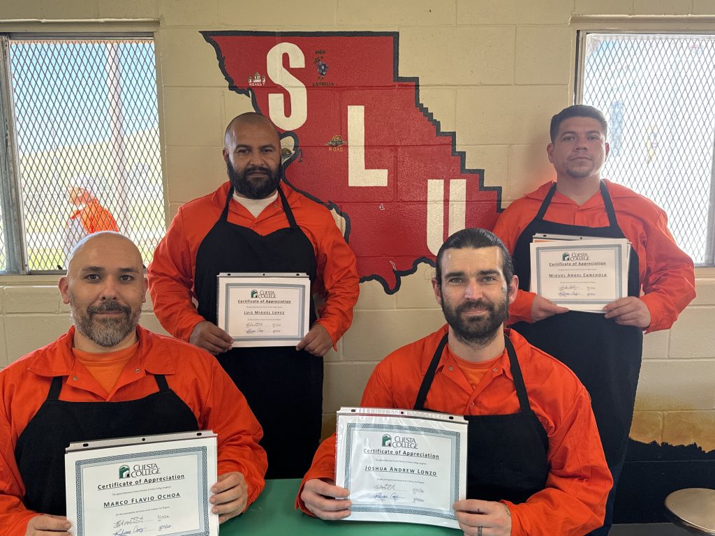 Graduates hold their food safety certifications at CMC.