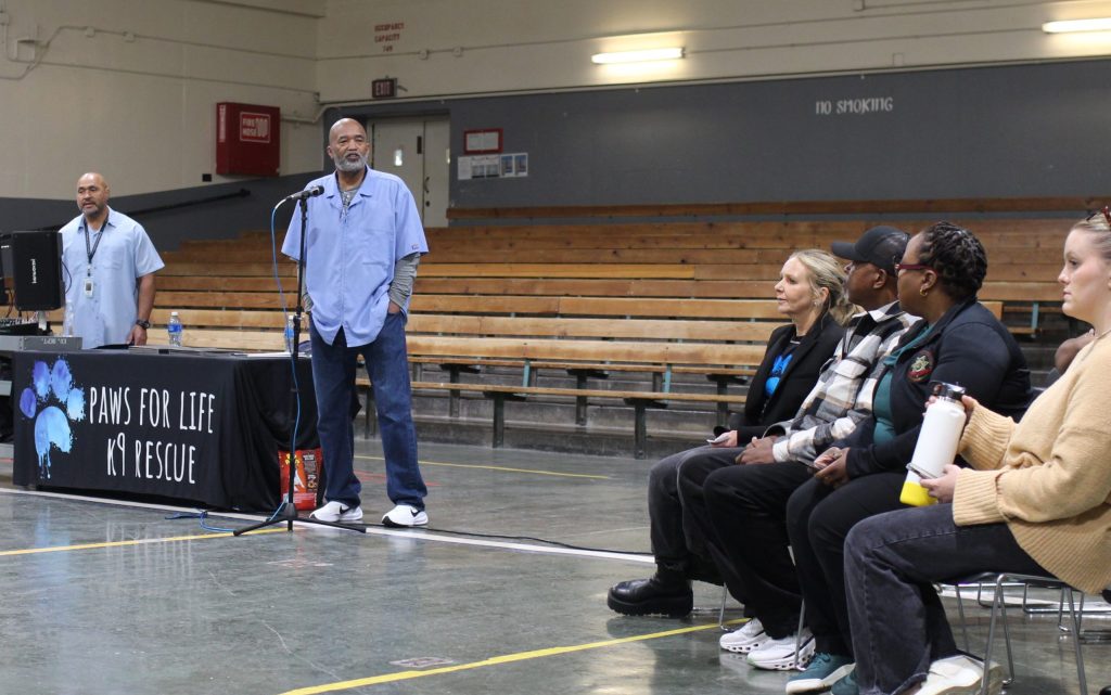Incarcerated people speak to others during the CMF Paws for Life banquet.