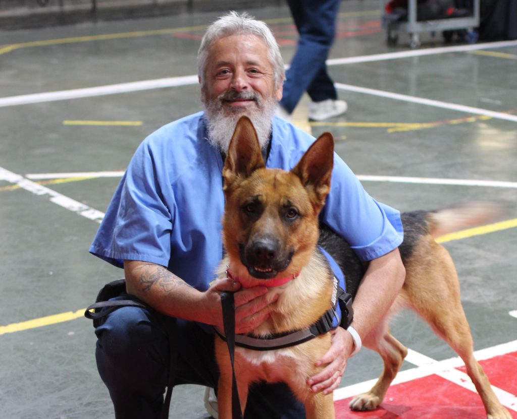 CMF incarcerated dog trainer with Paws for Life at the banquet.