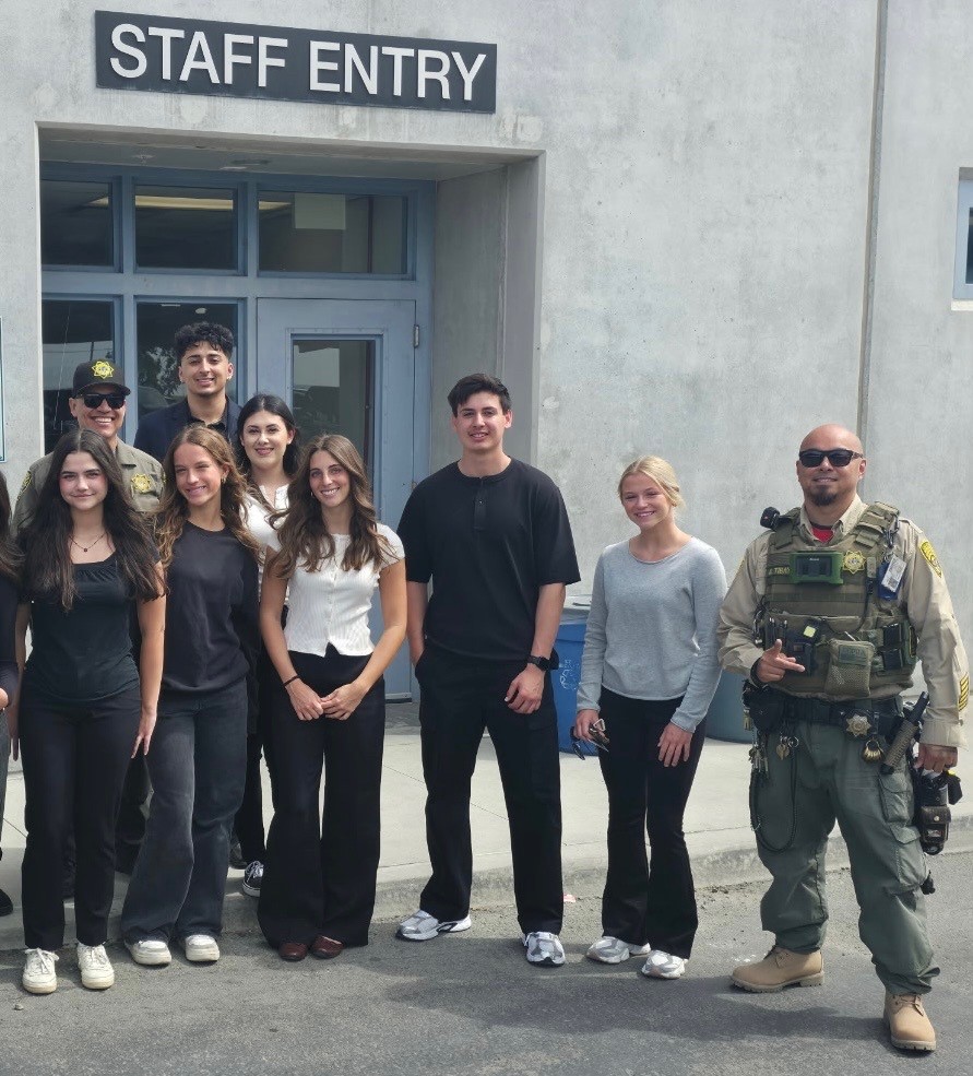 Students and staff stand in front of RJD entry