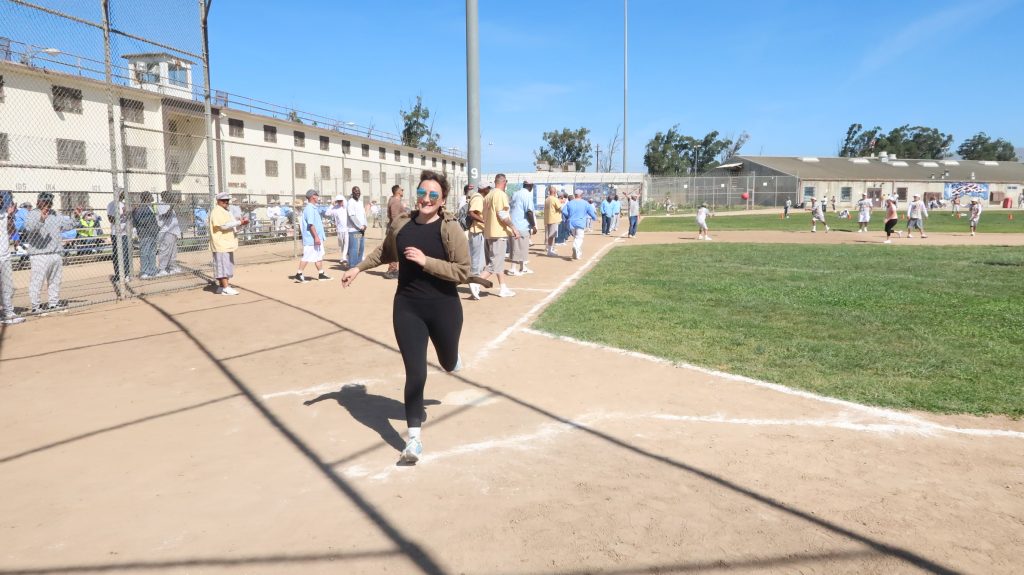 staff members runs on baseball field for fundraising event