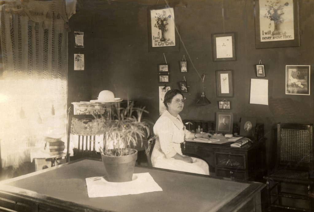 Historical photo of female matron sitting at her desk