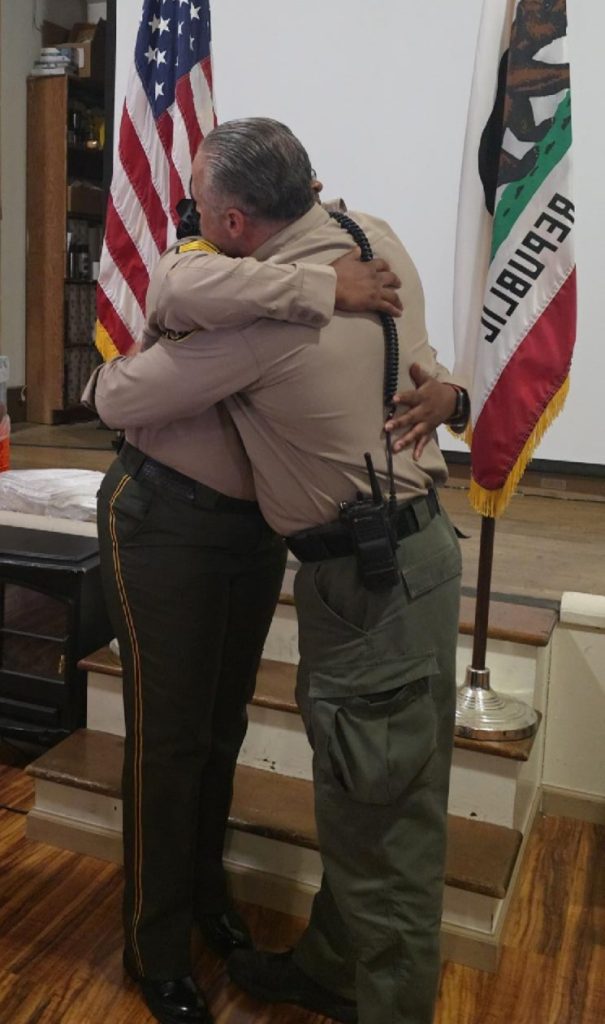 Two CDCR staff hug