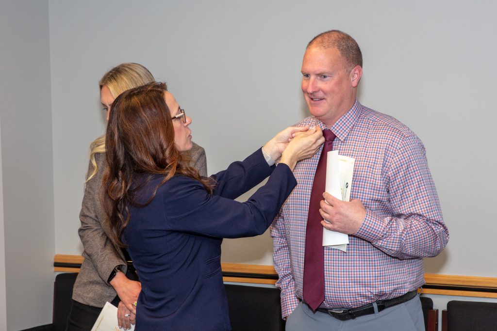 A CDCR executive pins Associate Warden Chris Siino.