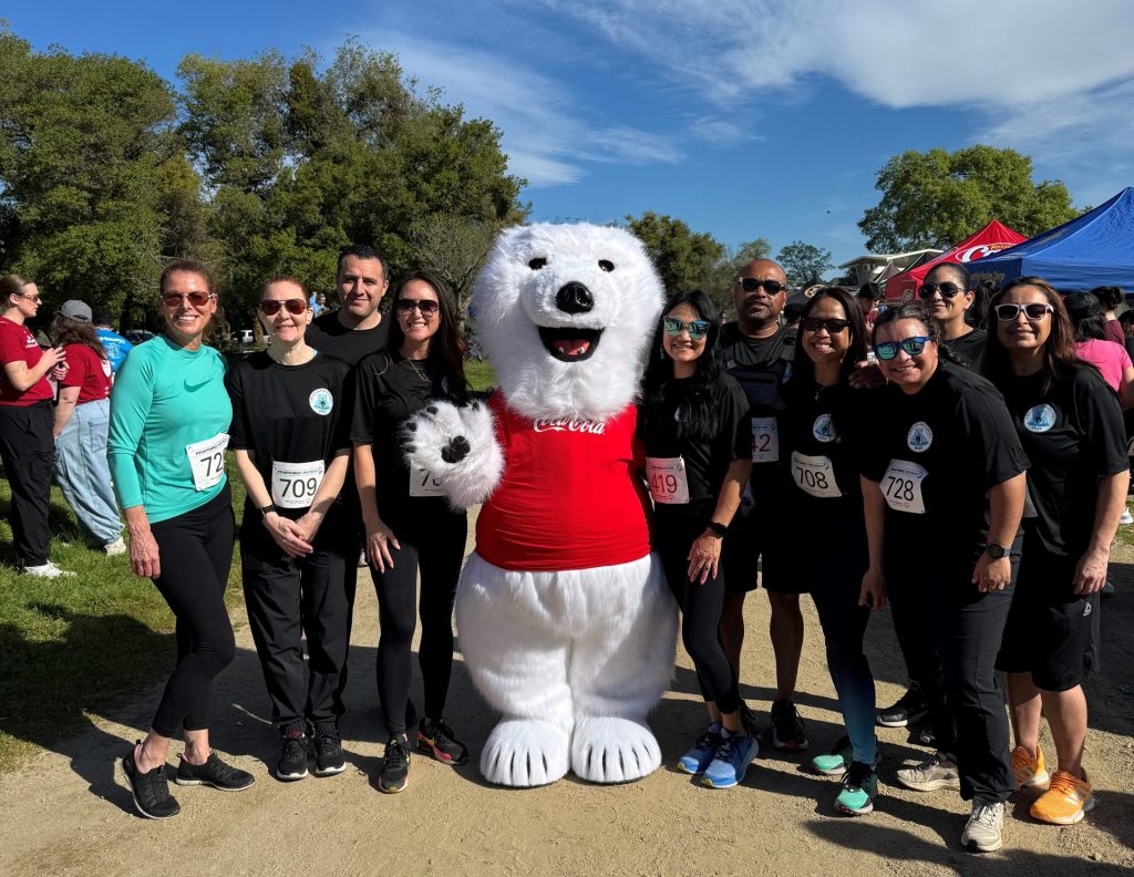 DAPO staff and family pose with polar plunge mascot, a polar bear