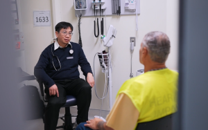 A doctor speaks with a patient inside a prison,