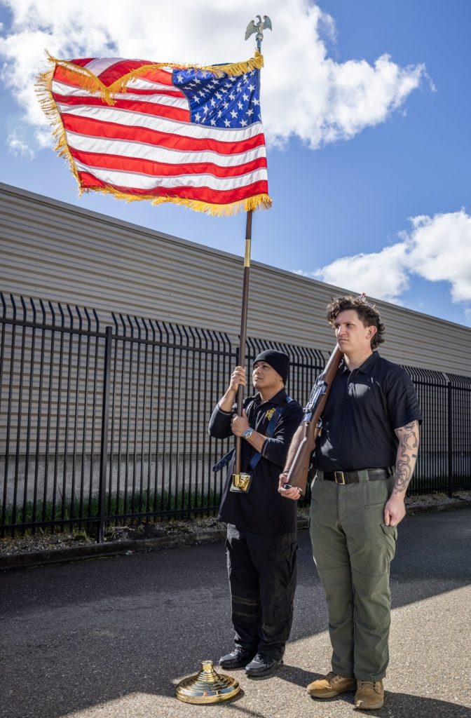 Two staff members with the American flag.