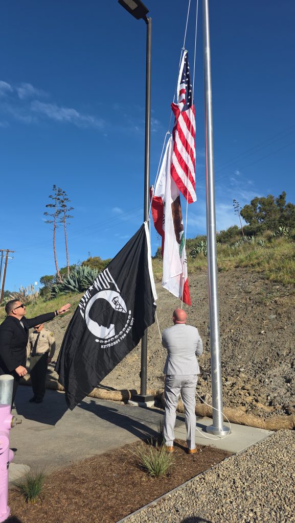 Two CDCR staff members raise flags