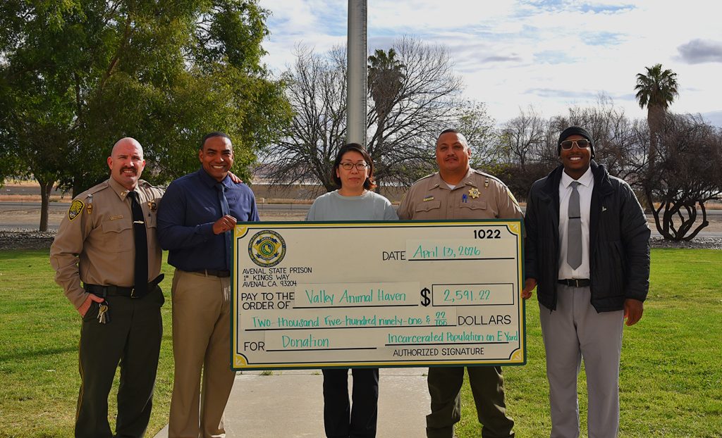 5 ASP staff stand holding oversized check to Valley Animal Haven donation in the amount of $2,591.22