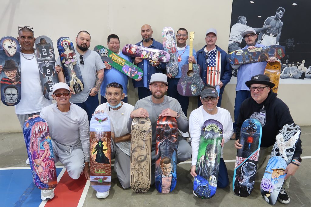 Group of incarcerated individuals present their skateboard artwork